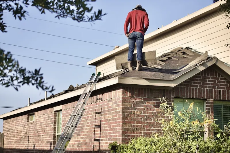 Professional roofer working on a residential roof in West Pioneer